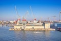 Berth cargo port with cranes on the background of the morning sky