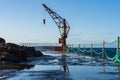 Berth with a crane on the north coast of the Atlantic Ocean, the village of El Pris.