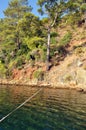 Berth line leading to mooring through green sea.