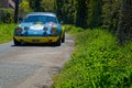 Porsche 911 on a narrow road during Tour Auto