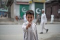 BESHAM, PAKISTAN - April 15, 2018: Unidentified young boy smiling with showing thumbs up on the street