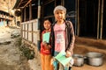 poor Nepalese girls in the Himalayan mountain region are holding school notebooks and pens from volunteer assistance to children