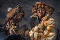 Bespectacled Experienced Mongolian Nomad In Fox Fur Coat, One Of The Participants Of Golden Eagle Festival.Man In Glasses With Gol