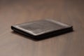 Bespoke brown all leather wallet on walnut table