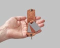 Bespoke brown leather key holder with printed family portrait in male hand