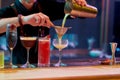 Best alcohol here. Close up of hands of male bartender pouring, mixing ingredients while making cocktails, alcoholic