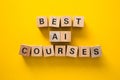 Best artificial intelligence ai courses written on wooden blocks on yellow background Royalty Free Stock Photo