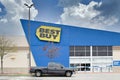 Best Buy business exterior storefront with a single vehicle in parking lot in Houston, TX.