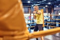 Best cardio. Athletic mature man in sportswear boxing while standing on the ring at gym