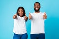 Happy African American couple gesturing thumbs up and smiling Royalty Free Stock Photo