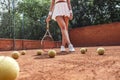 She is the best! Cropped image of sexy female tennis player on outdoor court. Sporty young woman with tennis racket and several Royalty Free Stock Photo