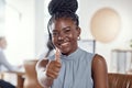 The best customer service by far. a young woman using a headset and showing thumbs up in a modern office. Royalty Free Stock Photo