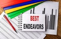 BEST ENDEAVORS text on notebook with folder on chart Royalty Free Stock Photo