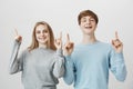 We are best in everything together. Portrait of confident friendly attractive man and woman, raising index fingers and Royalty Free Stock Photo