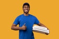 Black delivery man holding pizza boxes, showing thumbs up Royalty Free Stock Photo