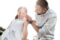 The best father ever. Kind young father adjusting hair clips for his cute daughter while spending time together outdoors