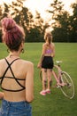 Best female friends with bicycle having fun