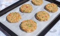 Best fish cakes raw uncooked on  baking tray. .Row of crab patties Royalty Free Stock Photo