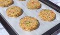 Best fish cakes raw uncooked on  baking tray. .Row of crab patties Royalty Free Stock Photo