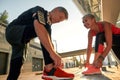 The best fitness partner. Active and healthy senior couple in sports clothing tying shoelaces before jogging together