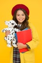 Best friend. girl hold dog toy and books. back to school. retro girl wear uniform and beret. kid school fashion Royalty Free Stock Photo