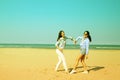 Best friends on beach similing and showing heart Royalty Free Stock Photo