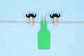 Best friends drink beer concept. Photo image of two clothes pins with mustache and huge green color bottle isolated pastel Royalty Free Stock Photo