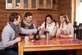 Best friends drinking hot tea in cosy kitchen at winter cottage Royalty Free Stock Photo