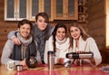 Best friends drinking hot tea in cosy kitchen at winter cottage Royalty Free Stock Photo