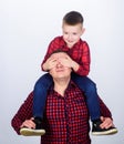 Best friends forever. Father little son red shirts family look outfit. Dad piggybacking adorable child. Happiness being Royalty Free Stock Photo