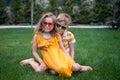 Best friends, happy family, love and happiness concept. Funny couple kids brother and sister sitting in park, cheerful Royalty Free Stock Photo