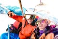 Best friends having fun taking selfie at chairlift with snowboard equipment on mountain ski resort - Winter friendship concept Royalty Free Stock Photo