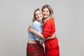 Best friends hugging. Portrait of two charming women in stylish casual clothes, isolated on gray background Royalty Free Stock Photo