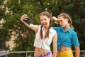 Best friends are photographed in park. Photo phone selfie