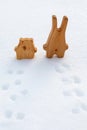 Best friends rabbit and bear are standing in snow and looking into expanse. Wooden toys to illustrate affection, love, emotional