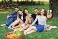 Best friends relax at picnic with guitar and fruits basket Royalty Free Stock Photo