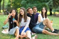 Best friends resting in park and blowing soap bubbles Royalty Free Stock Photo