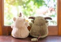 Best friends rhinoceros and buffalo toy sitting on brown window sill hugging each other and looking out of window Royalty Free Stock Photo