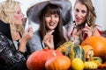 Best friends sharing candies while celebrating Halloween