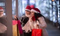 Best friends during a shopping madness in a mall with plenty of paper bags Royalty Free Stock Photo