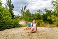 Best friends sitting on sand at beach. Royalty Free Stock Photo