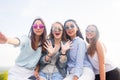 Best friends take selfies while walking in the Park. Four women wearing sunglasses are having a good day Royalty Free Stock Photo