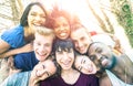 Happy best friends taking fun selfie at picnic with back lighting