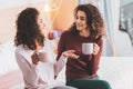 Two best friends gossiping while having tea time Royalty Free Stock Photo