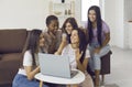 Group of young women using laptop together, shopping online or looking at photos Royalty Free Stock Photo