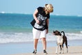 Best friends-Woman & pet dog walking on beach Royalty Free Stock Photo