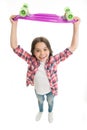 Best gift ever. Kid girl happy raising penny board. Child likes plastic skateboard as gift. Modern teen hobby. How to
