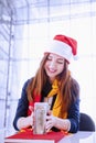 The best gift for the holidays is money. Young beautiful business woman with red Santa Hat is happy with the banknotes US Dollars Royalty Free Stock Photo