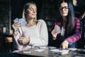 Best girls friends playing game card at home. Royalty Free Stock Photo