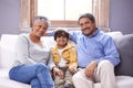 They are the best grandparents. Two grandparents sitting on a couch with their grandson. Royalty Free Stock Photo